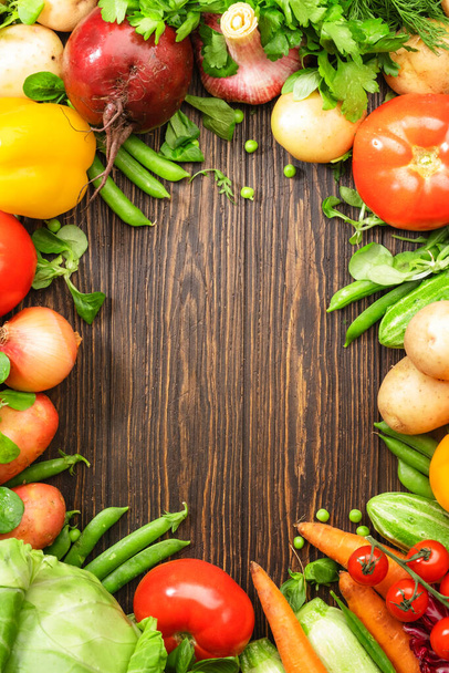 Assortment of fresh vegetables on wooden table frame background. Healthy organic food grocery concept. Copy space - Foto, Imagen