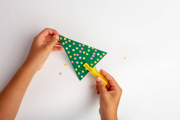 simple activity for cristmas holiday, kids hand making paper christmas tree - Photo, Image