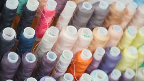 Multi colored bobbins of threads in workshop - Footage, Video