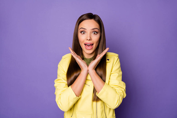 Photo of funky crazy lady long perfect groomed hairdo listen amazing news open mouth arms near face wear casual trend yellow leather jacket isolated pastel purple color background - Foto, imagen
