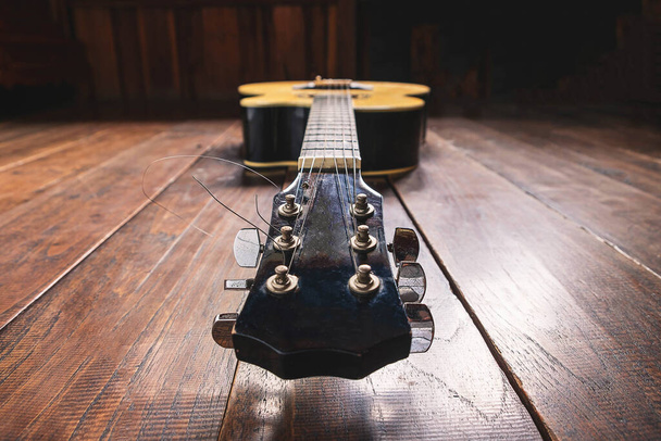 Acoustic guitar instrument on wooden background - Zdjęcie, obraz