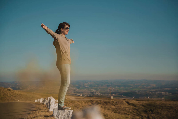 Woman enjoying the nature with arms raised - Фото, зображення