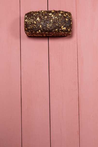 Fresh loaf of gluten free bread on pink background - Zdjęcie, obraz