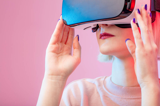 positive girl having fun with virtual reality goggles headset - Fotó, kép