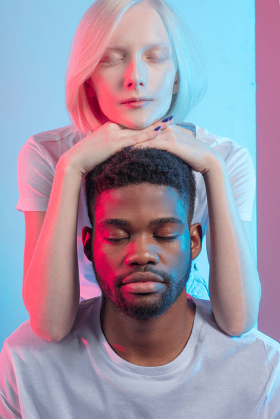 Portrait of calm beautiful mixed race couple with closed eyes . meditation - Foto, imagen