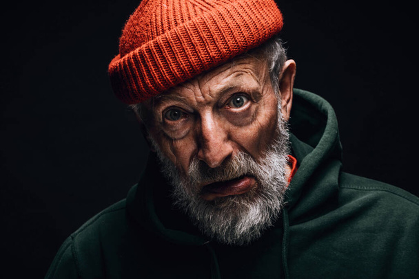 Elderly man portrait looking at camera with crazy confused expression. - Foto, imagen