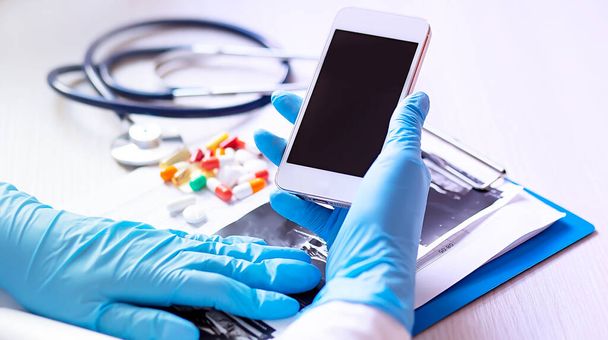 Close up hands doctor take smartphone, tablets, stethoscope ,healthcare. Medical concept - Фото, изображение