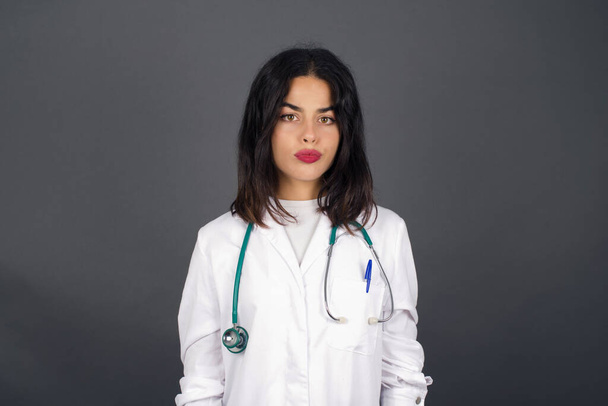 Attractive young doctor woman having stunned and shocked look, with jaw dropped, listening to friend's story in full disbelief, exclaiming: Wow, I can't believe this. Surprised girl. Shock - Photo, image