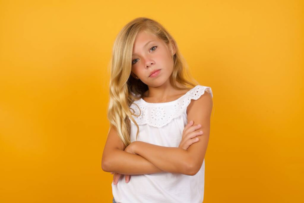 cute  girl   with arms crossed on yellow background  - Foto, Bild