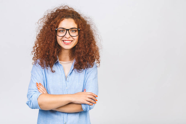 Portrait of smiling young curly business woman with crossed arms. Isolated over white background.  - Φωτογραφία, εικόνα