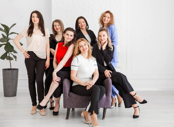 Happy women work team employees group looking at camera posing in studio, smiling women company staff workers, workforce members, business people managers standing together, portrait. Horizontal photo - Photo, Image