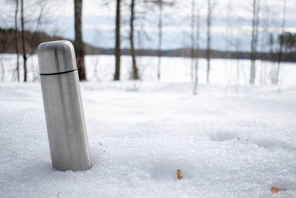 a thermos of hot tea in the forest, in the open air - Photo, Image