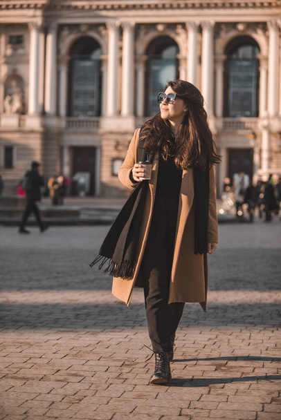portrait of stylish gorgeous woman in coat outdoors drinking coffee to go copy space - Photo, Image