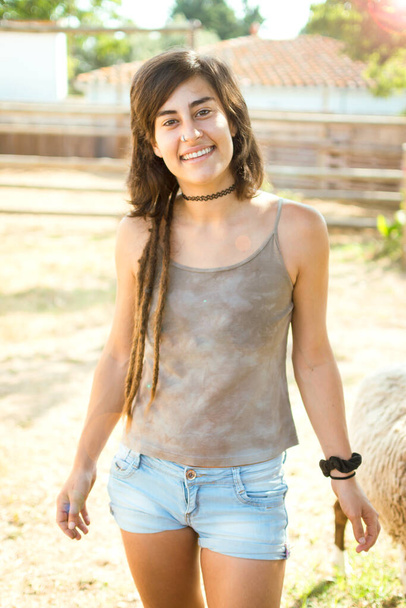 Close-up of a portrait of a girl with dreadlocks in country clothes. - Photo, Image