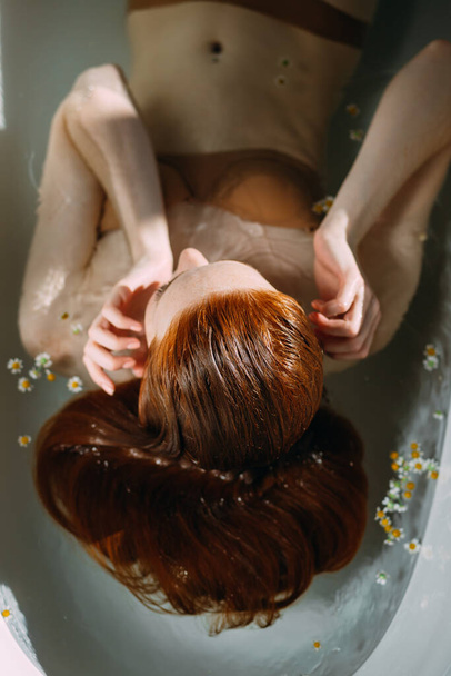 Beautiful woman relaxing in bathtub - 写真・画像