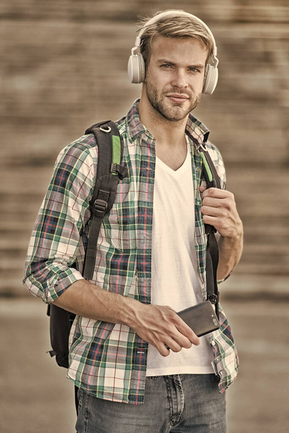 Listen music. Modern and digital youth. trendy man. College student earphones smartphone. Online education. Audio book concept. Educational technology. student e learning. school life - Photo, Image