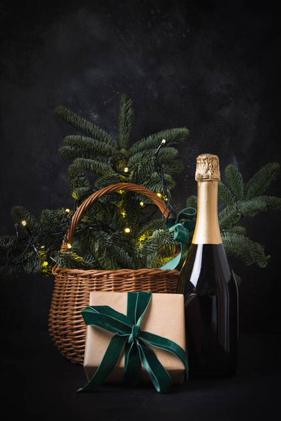 Holiday gift hamper with craft gift and sparkline wine on black. Christmas present. - Фото, изображение