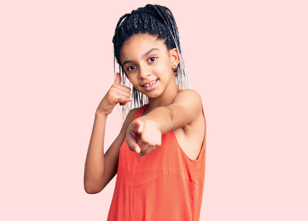 Cute african american girl wearing casual clothes smiling doing talking on the telephone gesture and pointing to you. call me.  - Photo, image
