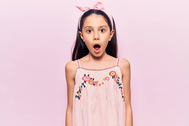 Beautiful child girl wearing casual clothes afraid and shocked with surprise expression, fear and excited face.  - Fotoğraf, Görsel