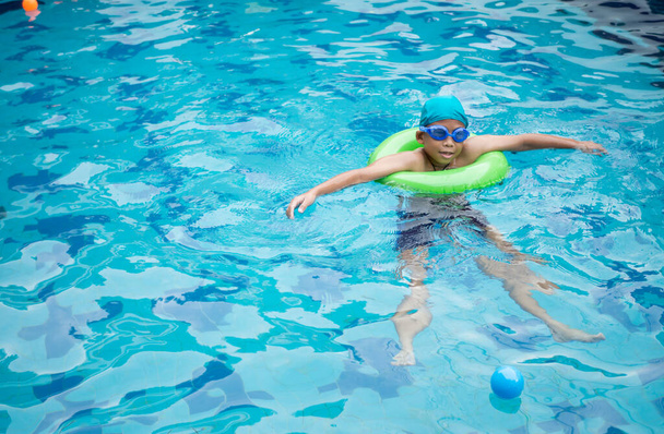Boy practicing swimming in the pool - Photo, Image
