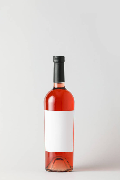 Bottle of wine with blank label on light background. Mockup for design - Fotoğraf, Görsel