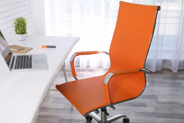 Comfortable workplace with office chair and wooden table - Photo, Image