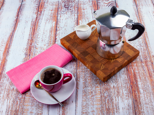 Table setting for coffee. Geyser coffee maker and cup with saucer - Foto, afbeelding