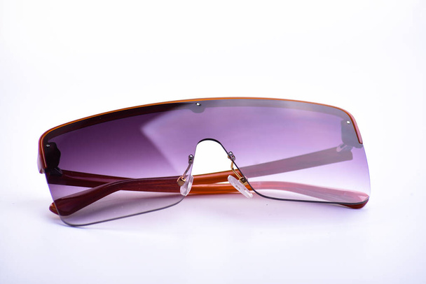Sunglasses closeup on a white isolated background - 写真・画像
