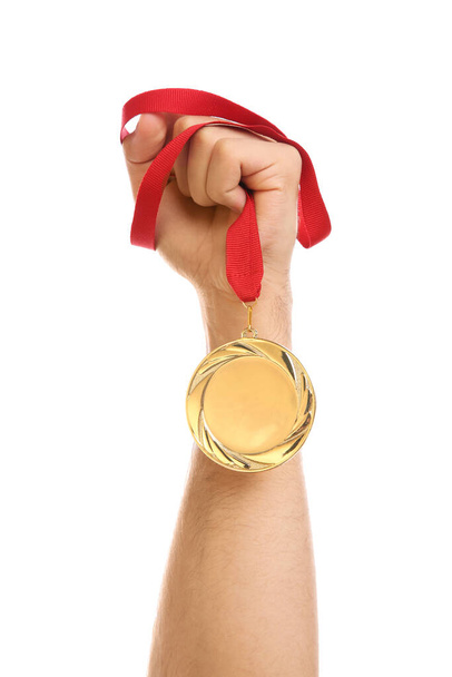 Man holding golden medal on white background, closeup. Space for design - Fotó, kép