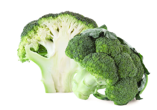 Fresh cut and whole broccoli on white background - 写真・画像