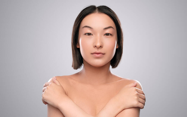 Ethnic female model touching shoulders - Foto, imagen