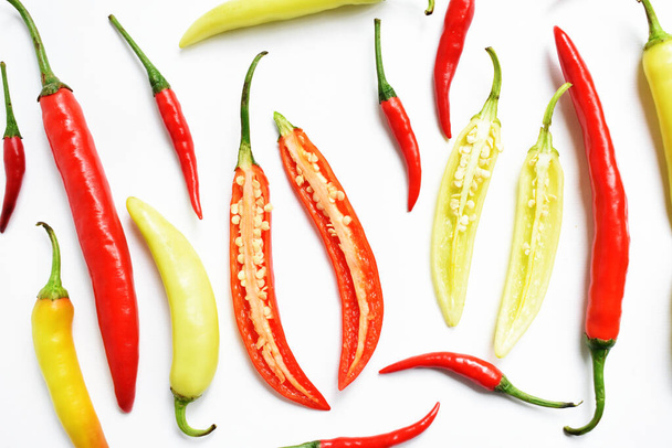 Red chili, green yellow chili peppers slices/cut/half isolated in white background, flay lay, top view, Thai chili in white table - Photo, Image