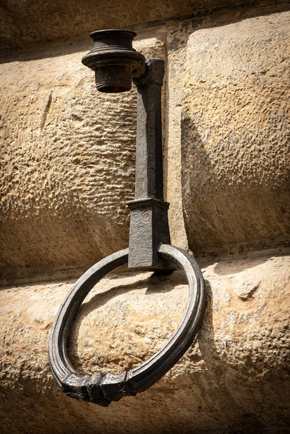 Ancient wrought iron ring for tying with rope the animals, horses, mules or cattle, on a stone wall (ashlar). Florence downtown, Tuscany, Italy, Europe - Photo, Image