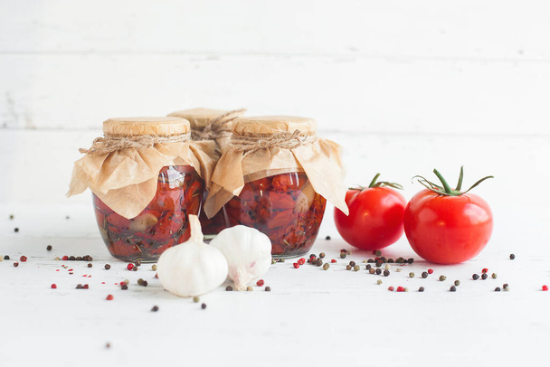 Tomatoes in the jar. Homemade sun dried tomatoes. temporary closing-down. Summer and autumn canned food. conserve with spices and vegetables. - Photo, Image