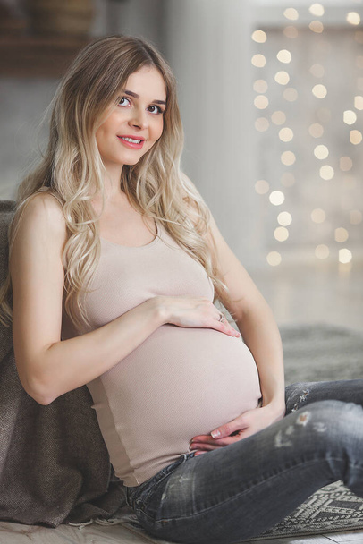 Beautiful young pregnant woman on christmas background - Photo, Image