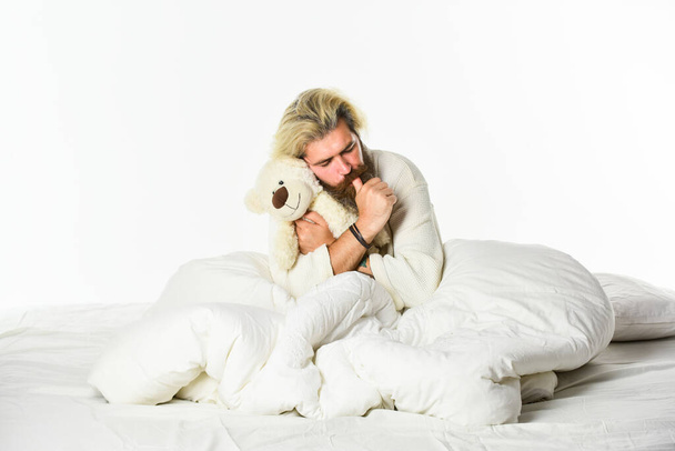 Present for partner. Toys shop concept. playing in bed. mature man has childish habits. cute and romantic playful adult. brutal male express tenderness to teddy bear toy. sweet dreams - Foto, afbeelding