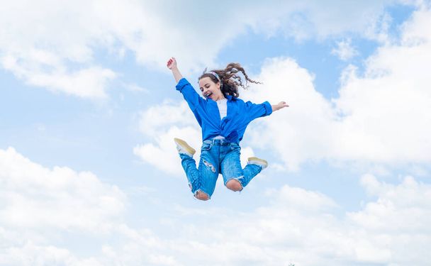free your imagination. kid beauty and fashion. child jump in casual style. Child jumping on background of sky. summer holiday concept. childhood happiness. happy childrens day. Beautiful female - Foto, Bild