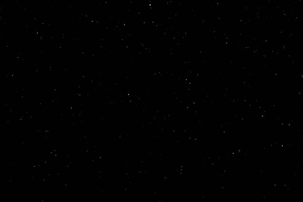 White bokeh on a black background. light spots texture. falling snow. star sky. - Photo, Image