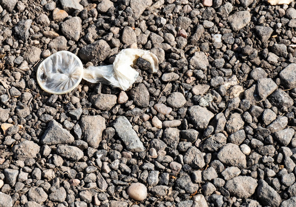 Discarded used contraceptive sheath on the ground - Photo, Image