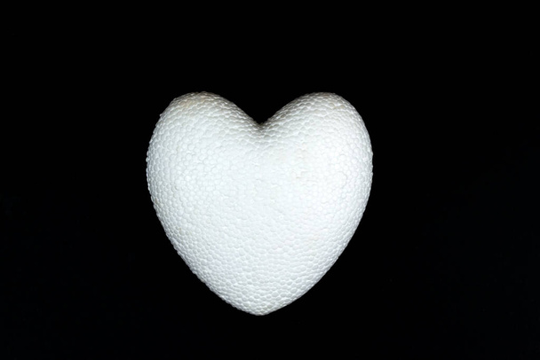 White heart symbol of love and invitation for valentines day concept.Black background. close-up - Photo, Image
