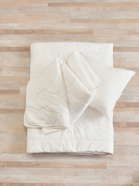 Colcha blanca y almohada, libro, algodón y reloj objeto, decoración cómoda. - Foto, imagen