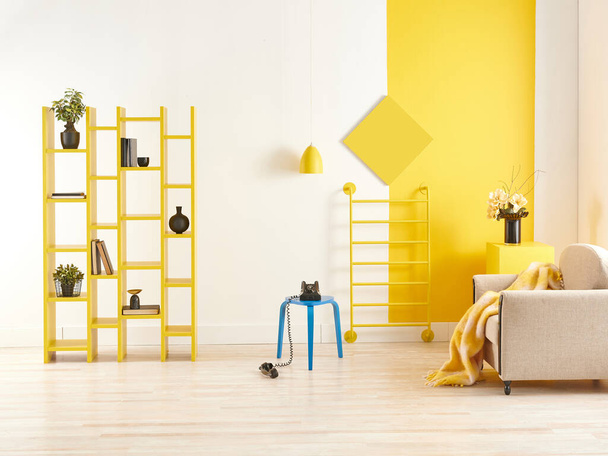 Yellow and white wall background, decorative bookshelf and book, coffee table, lamp. - Foto, Imagem
