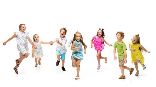 Happy little caucasian kids jumping and running isolated on white background - Foto, imagen