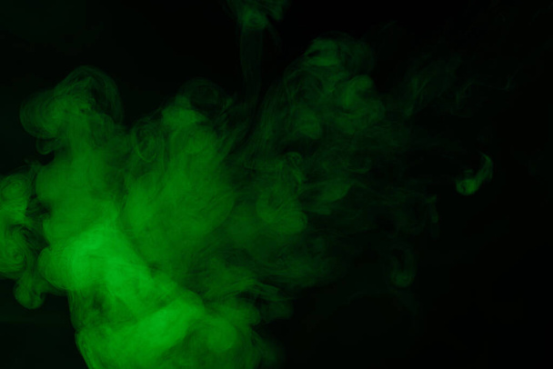 Green steam on a black background. Copy space. - Foto, Imagen