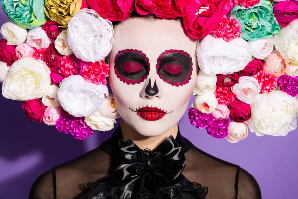 Happy Death Day. Photo of voodoo witch closed eyes religion ritual dead folklore creature face print katrina scary makeup wear floral headwear band black costume isolated purple background - Zdjęcie, obraz