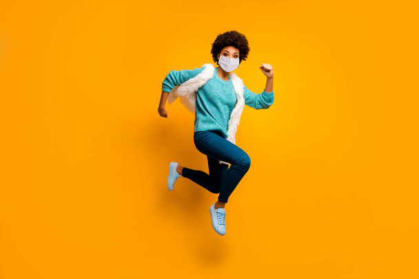 Full length body size view of her she attractive healthy active purposeful girl wearing mask jumping running stop mers cov flu grippe healthcare isolated bright yellow color background - Photo, Image