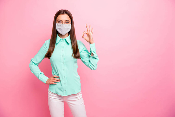 Portrait of her she nice attractive pretty healthy girl wearing safety mask showing ok-sign healthcare stop flue contamination recovery syndrome stay home isolated pink color background - Фото, изображение