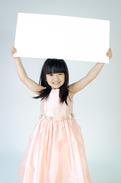 Portrait of young Asian girl holding blank billboard - Fotoğraf, Görsel