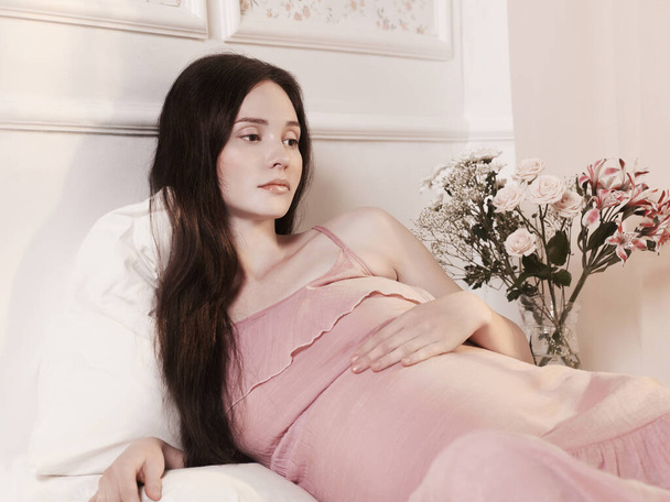 Portrait of a young pregnant woman in classic home interior.  - Фото, изображение