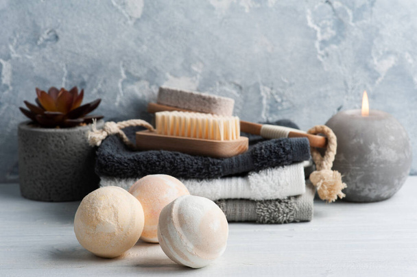 Spa composition with body brushes and towels. Aromatherapy arrangement, zen still life on concrete blue gray background - Fotografie, Obrázek